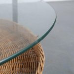 m25665 1960s Round coffee table on black metal base with wicker magazine shelf and glass top Netherlands