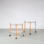m26962 1970s Side table or trolley in beech plywood with gently curved ends, two round glass tops, on black wheels Denmark