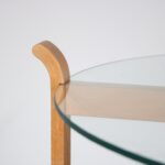 m26962 1970s Side table or trolley in beech plywood with gently curved ends, two round glass tops, on black wheels Denmark
