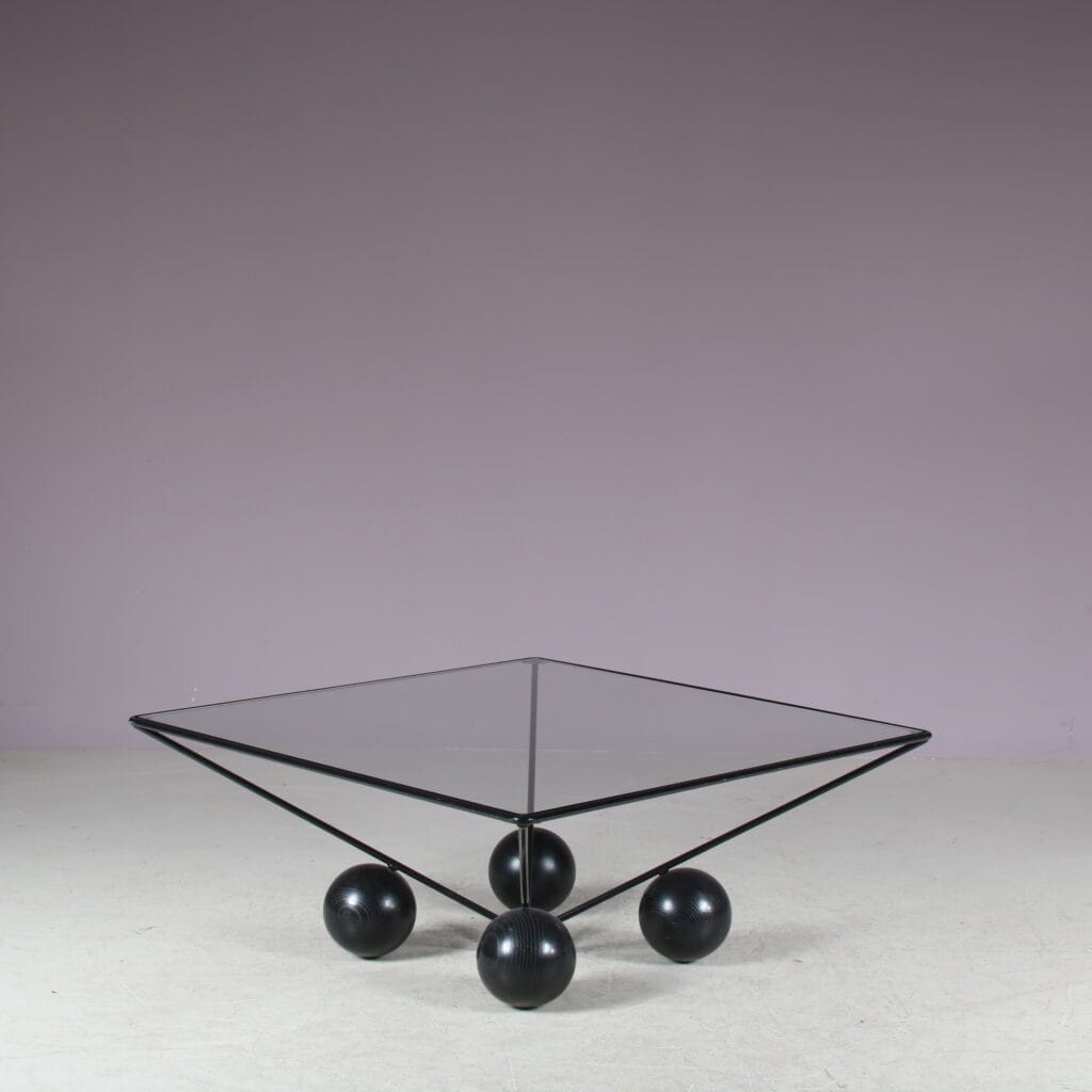 m27824 1980s Square coffee table on black metal base with black wooden ball shaped feet and glass top / Italy