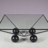 m27824 1980s Square coffee table on black metal base with black wooden ball shaped feet and glass top / Italy