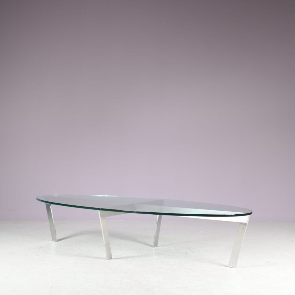 m27846 1980s Oval coffee table with stainless steel base and thick glass top Netherlands