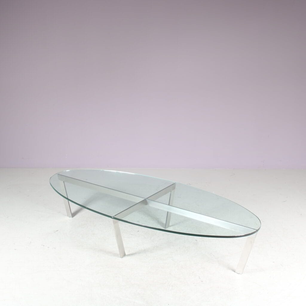 m27846 1980s Oval coffee table with stainless steel base and thick glass top Netherlands