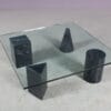 m27894 1980s Coffee table with four marble feet and glass top in the style of Vignelli (Metafora) / Italy