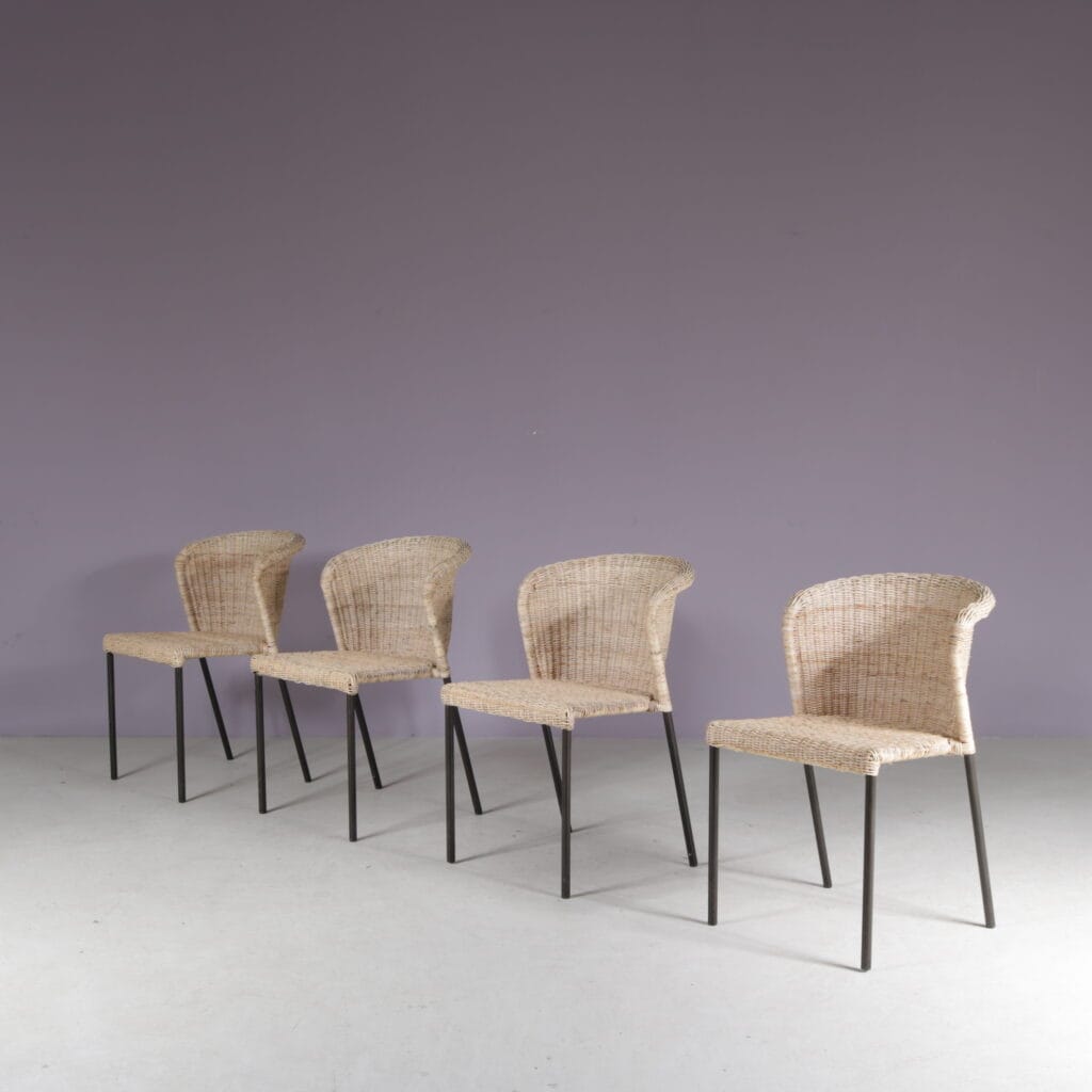 m28077 1950s Set of 4 dining chairs on black metal base with wicker upholstery, Netherlands