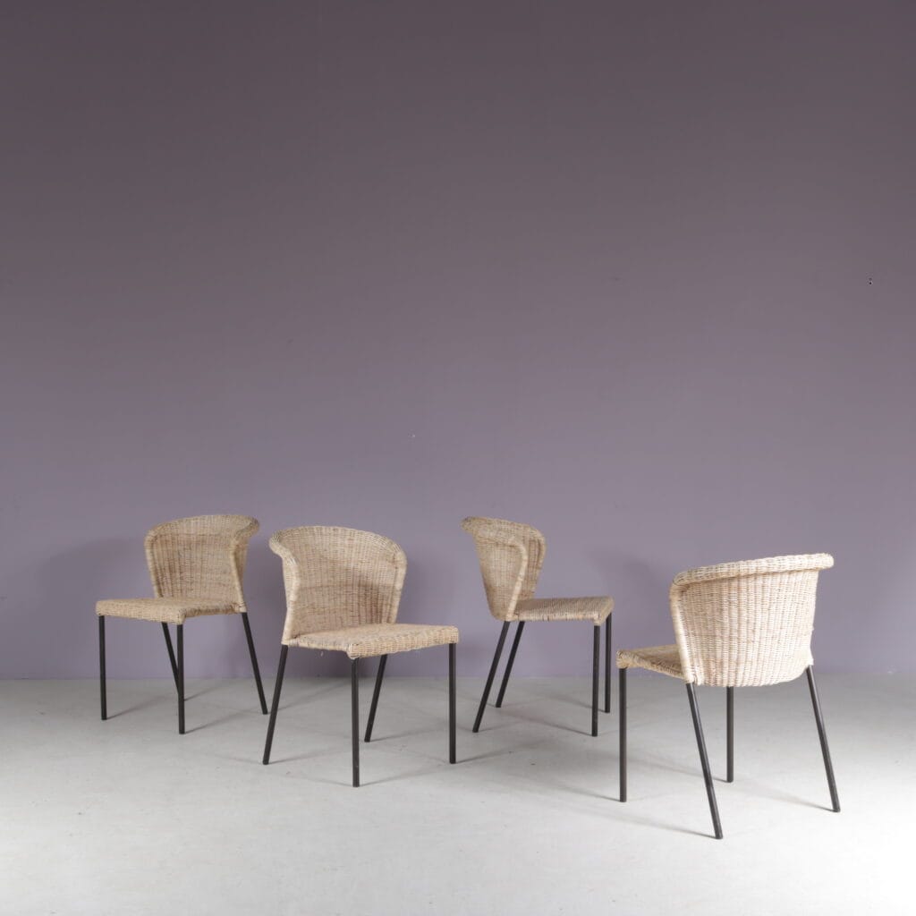 m28077 1950s Set of 4 dining chairs on black metal base with wicker upholstery, Netherlands
